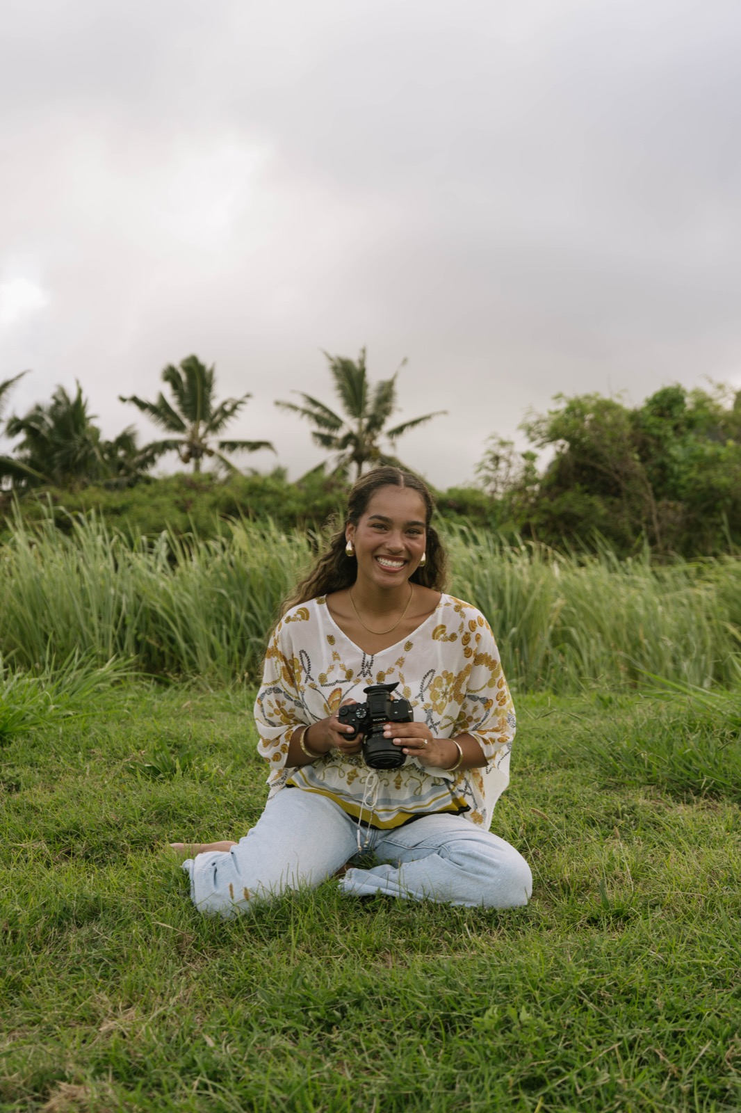 Khiara Salvani holding her camera in a grassy field