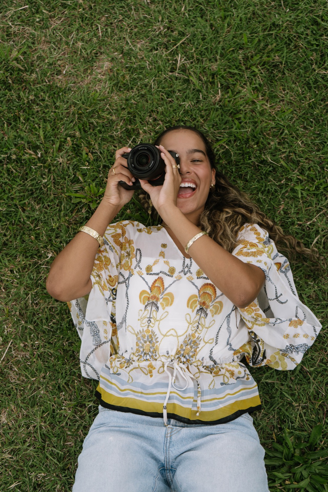 Khiara Salvani laughing while holding her camera up to take a photo